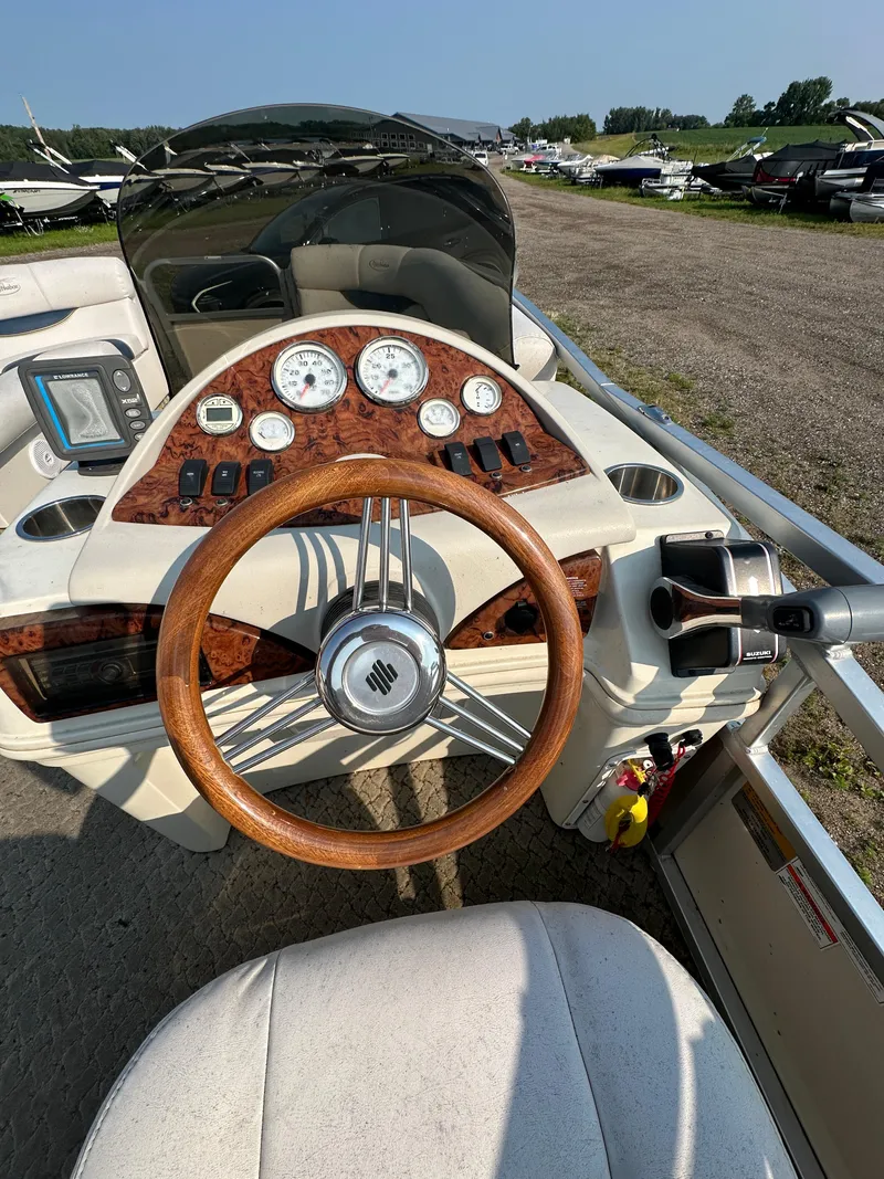 Slide: The Image of 2008 Misty Harbor 2085GM Grand Mistique boat dashboard with wood accents and steering wheel. - 6