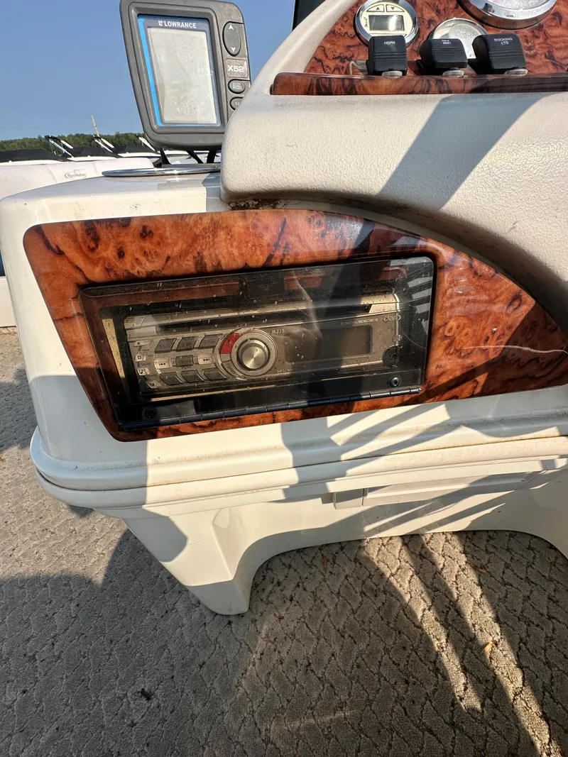 Slide: The Image of 2008 Misty Harbor 2085GM Grand Mistique dashboard with wood paneling and stereo system. - 8