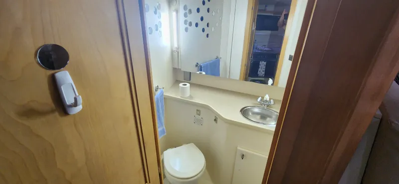 Slide: The Image of Bathroom interior of 1996 Carver 400 Cockpit Motor Yacht with sink and toilet. - 20