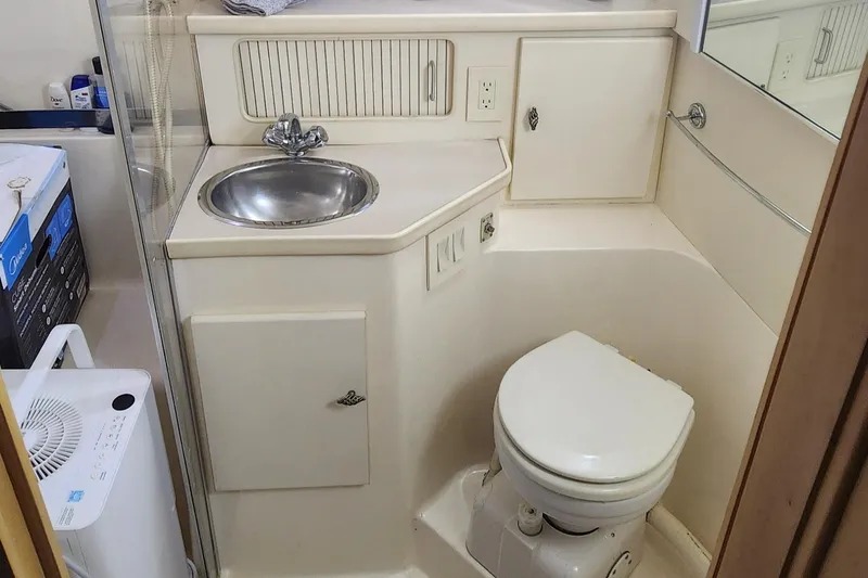 Slide: The Image of Bathroom interior of 1996 Carver 400 Cockpit Motor Yacht with sink and toilet. - 23