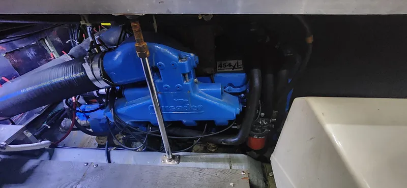 Slide: The Image of Engine compartment of 1996 Carver 400 Cockpit Motor Yacht, featuring a blue engine. - 24