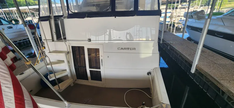 Slide: The Image of 1996 Carver 400 Cockpit Motor Yacht docked in marina. - 6