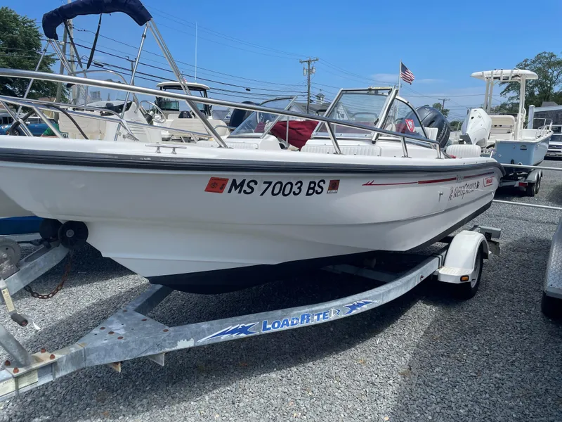 Slide: The Image of 2001 Boston Whaler 160 Ventura boat on trailer, parked on gravel lot. - 11