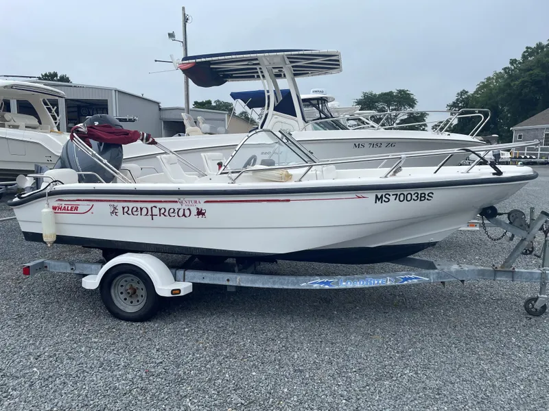 Slide: The Image of 2001 Boston Whaler 160 Ventura boat on trailer in a marina setting. - 12