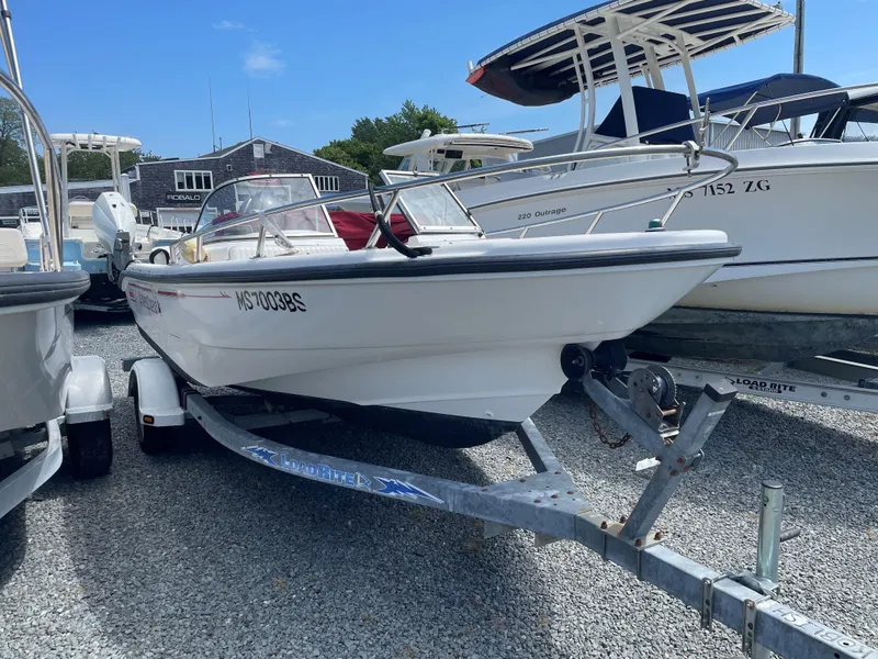 Slide: The Image of 2001 Boston Whaler 160 Ventura boat on trailer in marina setting. - 2