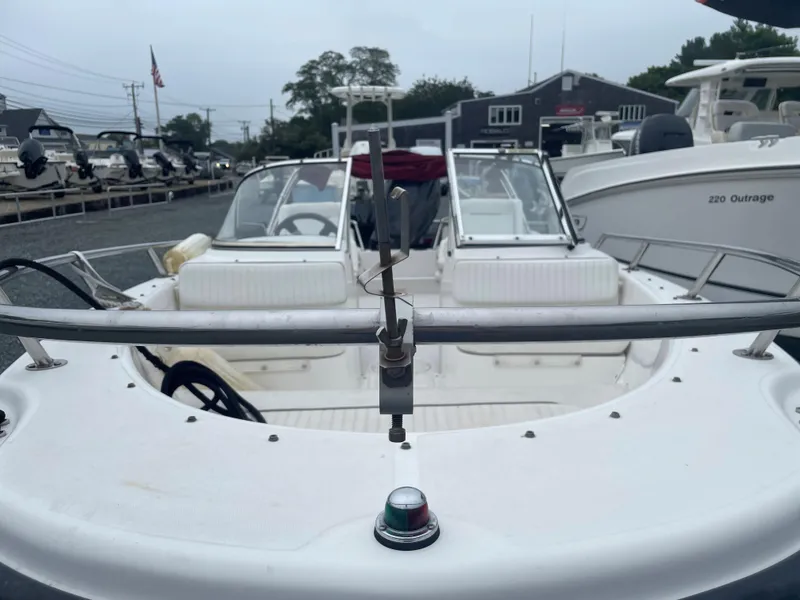 Slide: The Image of 2001 Boston Whaler 160 Ventura boat docked, showcasing seating and control area. - 3