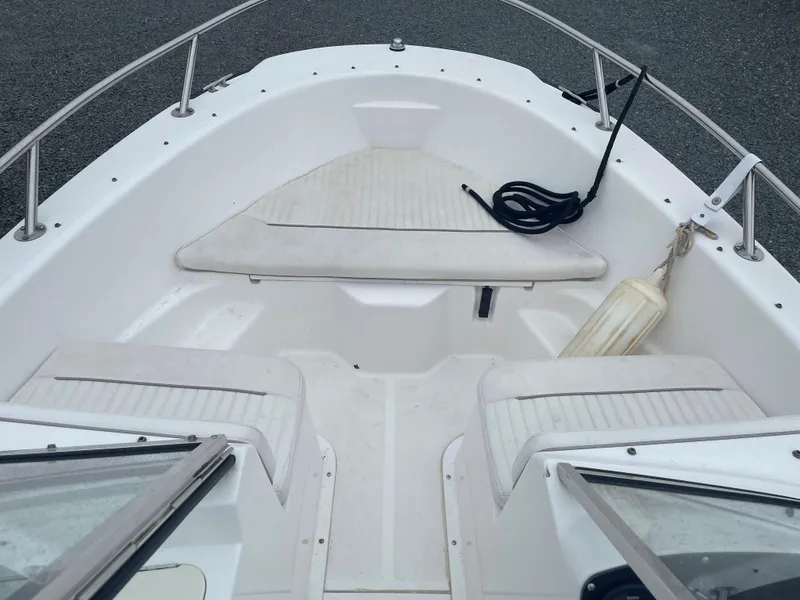 Slide: The Image of 2001 Boston Whaler 160 Ventura boat interior with seating and railing. - 4