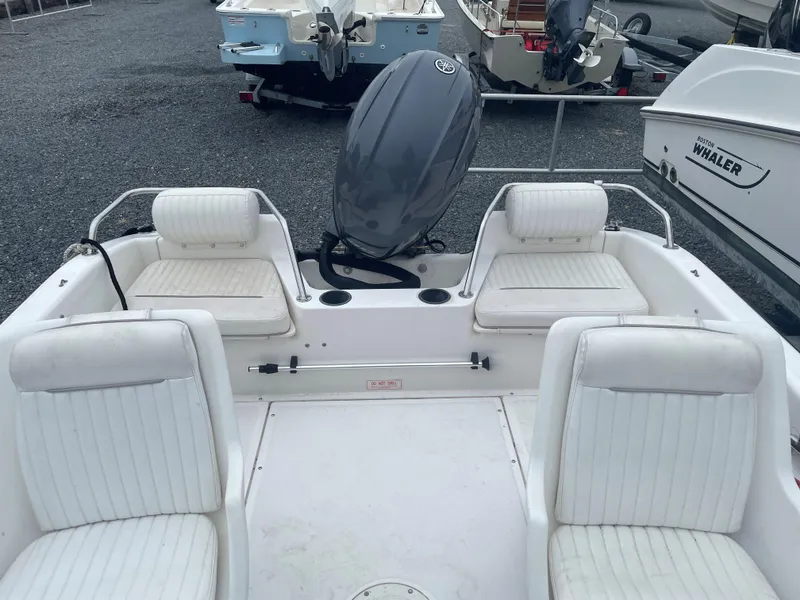 Slide: The Image of 2001 Boston Whaler 160 Ventura boat interior with seating and motor. - 5