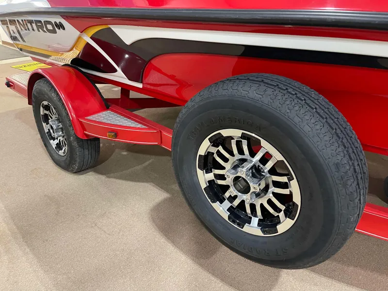 Slide: The Image of Red 2011 Nitro Z-7 boat trailer with stylish black and white wheels. - 14