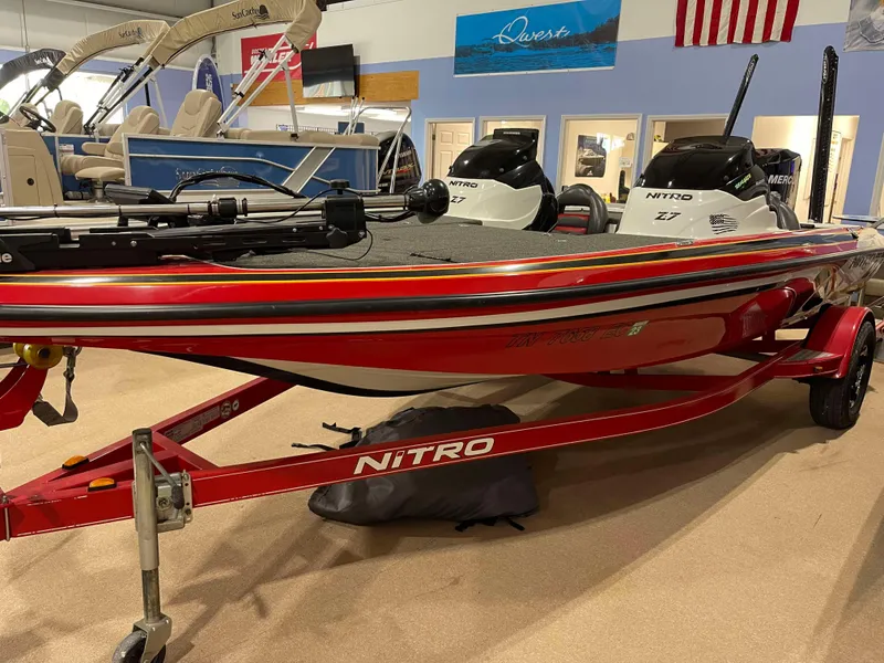 Slide: The Image of 2011 Nitro Z-7 red boat on display in showroom with trailer. - 2
