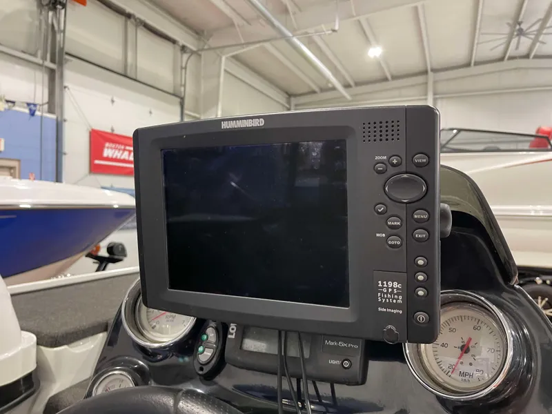 Slide: The Image of Humminbird fish finder on 2011 Nitro Z-7 boat dashboard in a garage setting. - 6