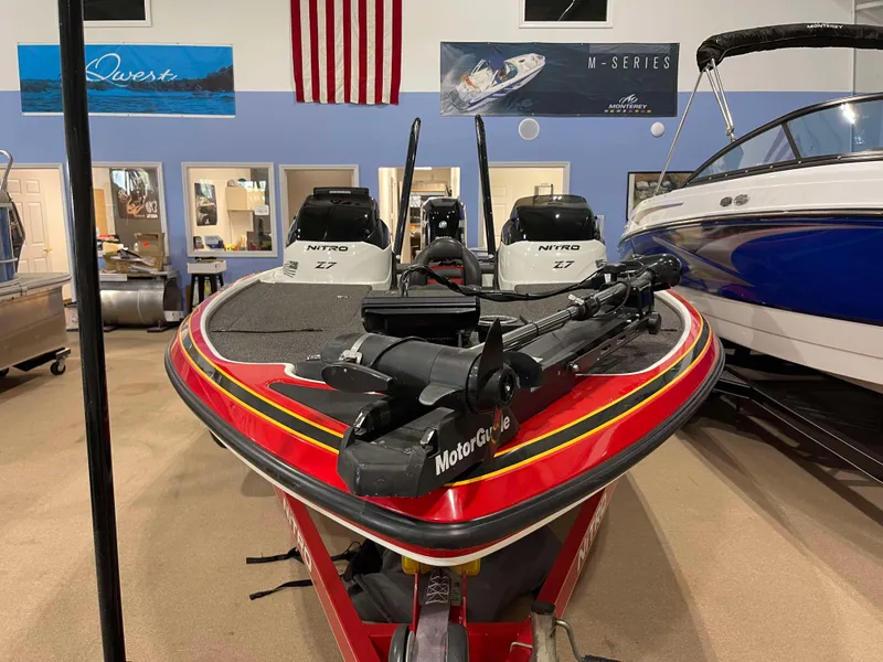 Slide: The Image of 2011 Nitro Z-7 boat in showroom with American flag backdrop. - 8