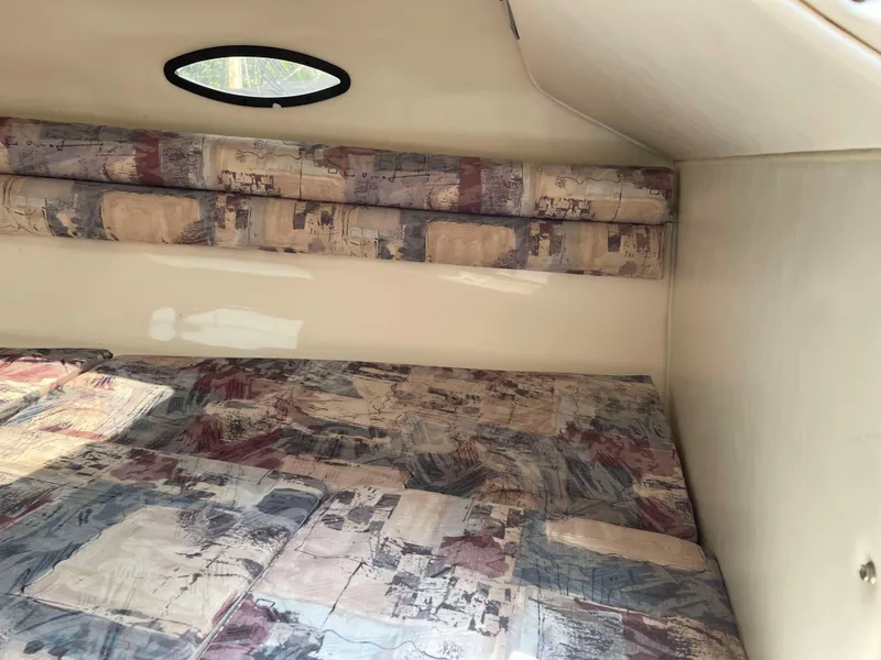 Slide: The Image of 1998 Rinker 212 Captiva Cuddy cabin interior with patterned upholstery. - 10