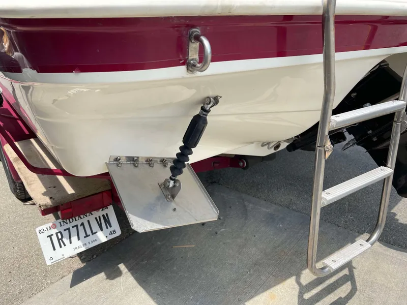 Slide: The Image of 1998 Rinker 212 Captiva Cuddy boat stern with ladder and Indiana license plate. - 16