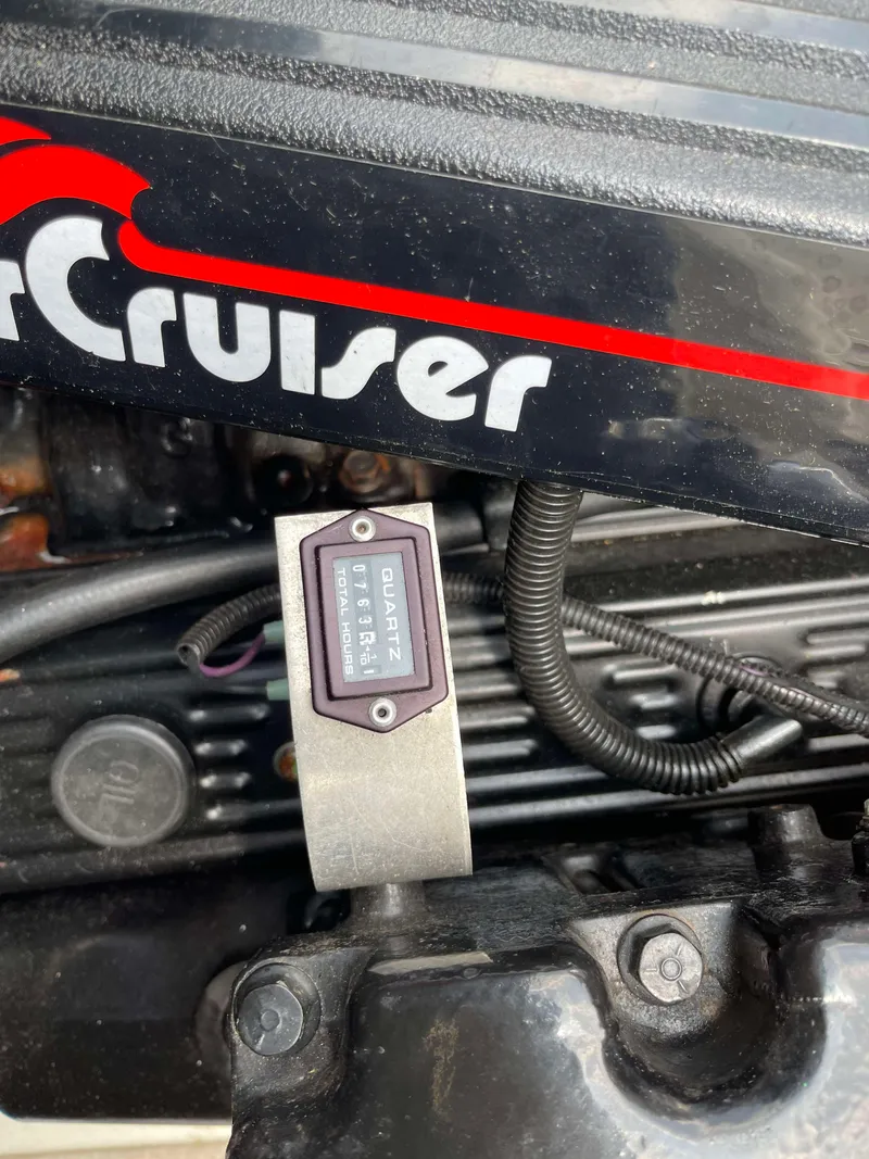 Slide: The Image of Close-up of a 1998 Rinker 212 Captiva Cuddy engine component. - 18