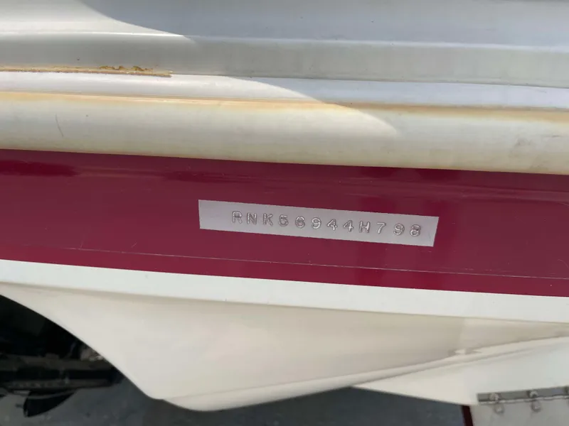 Slide: The Image of 1998 Rinker 212 Captiva Cuddy boat with visible hull identification number. - 23