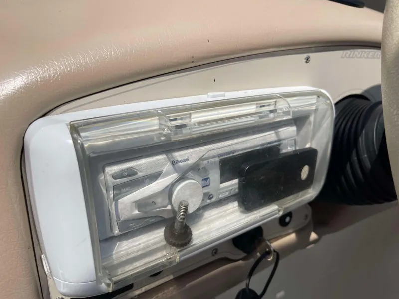 Slide: The Image of 1998 Rinker 212 Captiva Cuddy dashboard with stereo system. - 6