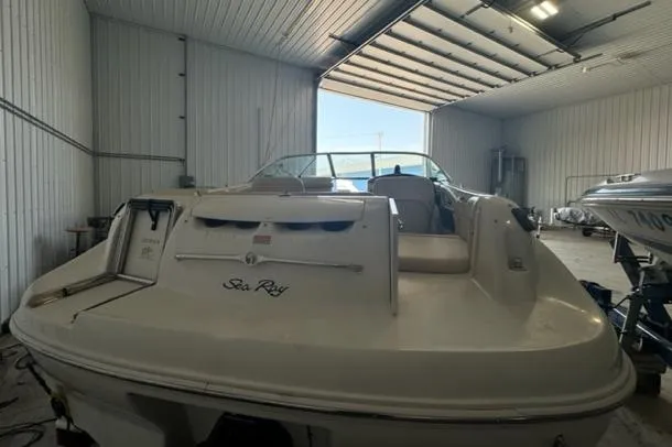 Slide: The Image of 2000 Sea Ray 210 Bow Rider boat in a storage facility. - 12