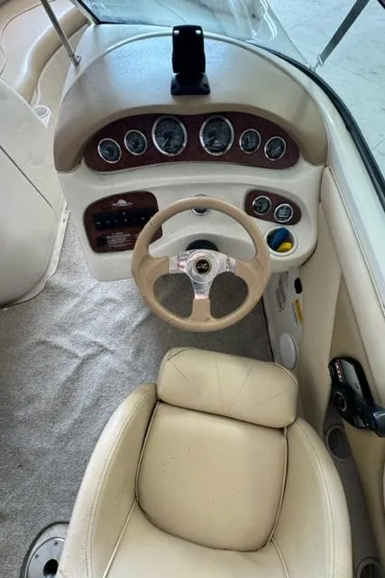 Slide: The Image of Interior view of 2000 Sea Ray 210 Bow Rider boat dashboard and steering. - 4