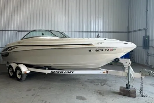 Slide: The Image of 2000 Sea Ray 210 Bow Rider on ShoreLand'r trailer in a garage. - 9