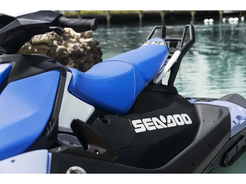 Slide: The Image of 2024 Sea-Doo Spark 3up 90 hp iBR jet ski with blue seat by the water. - 4