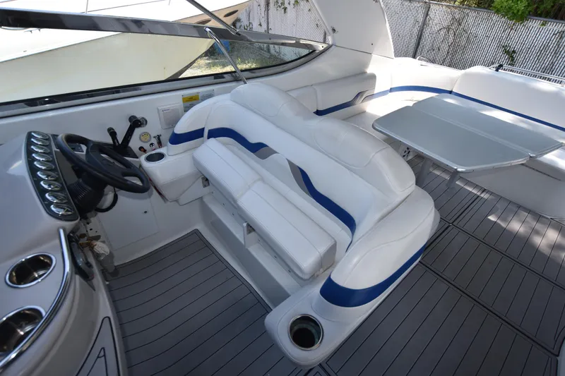 Slide: The Image of 2004 Formula 400 Super Sport boat interior with white seating and steering wheel. - 11