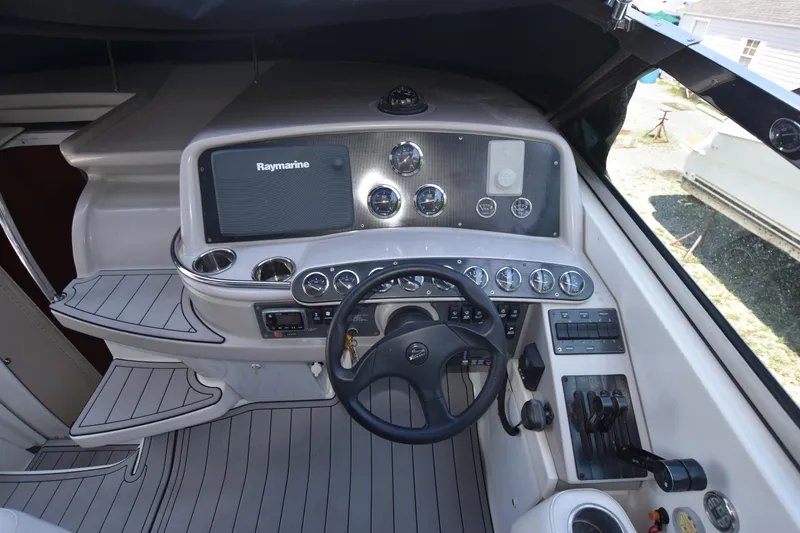 Slide: The Image of 2004 Formula 400 Super Sport boat cockpit with steering wheel and control panel. - 12