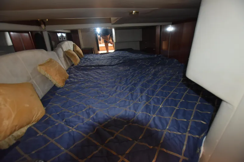Slide: The Image of Interior cabin of 2004 Formula 400 Super Sport with blue bedding and pillows. - 23