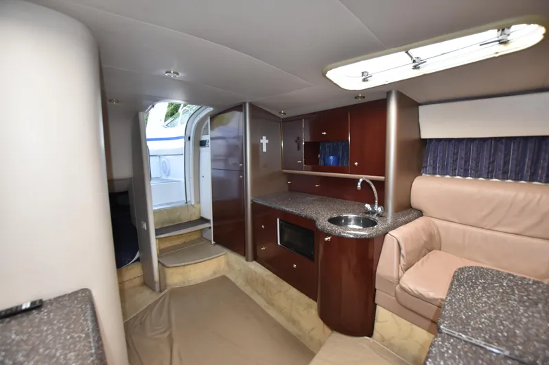Slide: The Image of 2004 Formula 400 Super Sport yacht interior with kitchenette and seating area. - 25