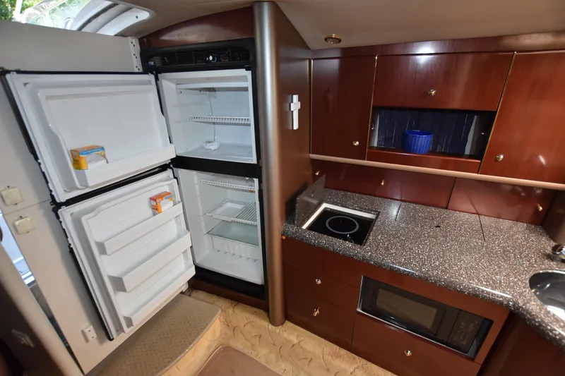 Slide: The Image of 2004 Formula 400 Super Sport yacht kitchen with fridge, stove, and microwave. - 26