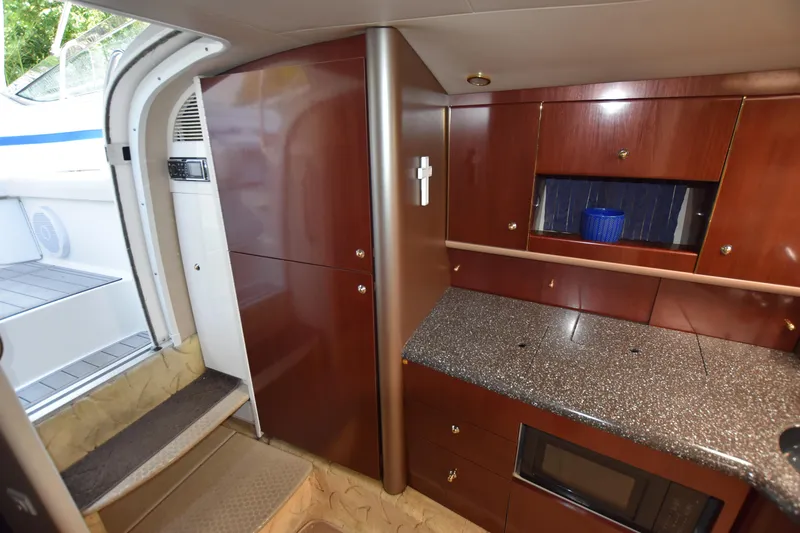 Slide: The Image of 2004 Formula 400 Super Sport yacht interior with wood cabinetry and granite countertops. - 27