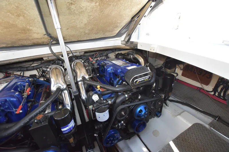 Slide: The Image of Engine compartment of 2004 Formula 400 Super Sport boat, featuring dual blue engines. - 34