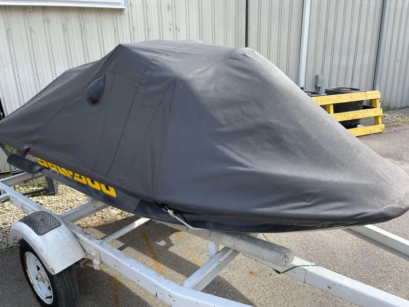 Slide: The Image of Covered 2002 Sea-Doo RX jet ski on trailer, parked outdoors. - 13