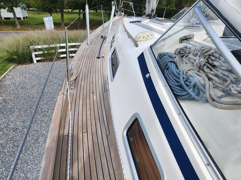 Slide: The Image of 2016 Hallberg-Rassy 342 sailboat deck with coiled ropes and wooden finish. - 17