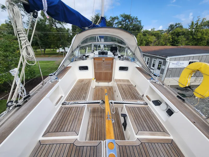 Slide: The Image of 2016 Hallberg-Rassy 342 sailboat cockpit with wooden deck and blue canopy. - 19