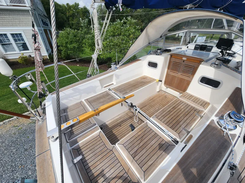 Slide: The Image of 2016 Hallberg-Rassy 342 sailboat cockpit with teak flooring and steering wheel. - 20
