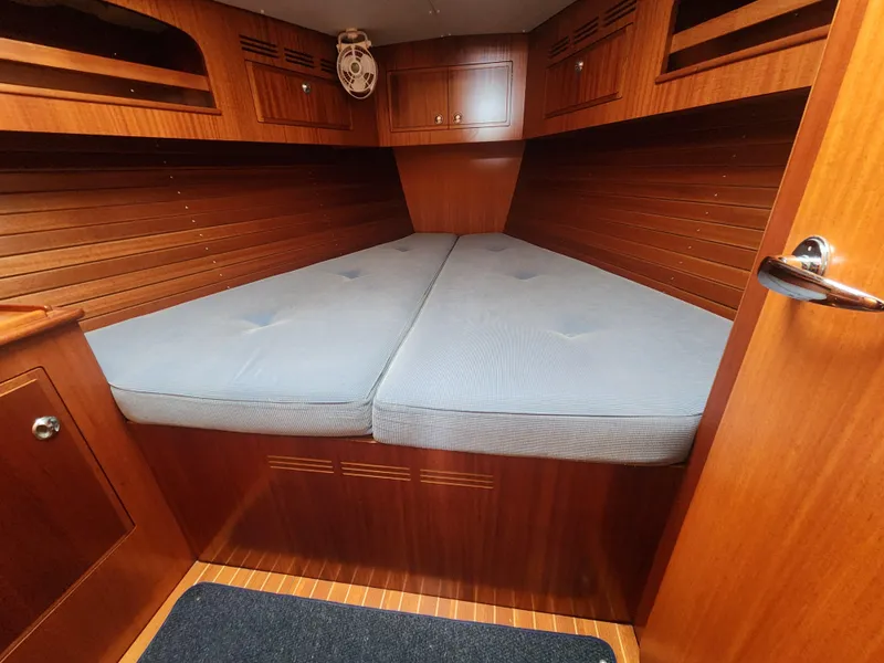 Slide: The Image of Cozy cabin interior of 2016 Hallberg-Rassy 342 yacht with wooden finish and comfortable bedding. - 29