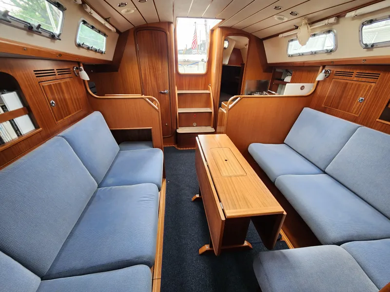 Slide: The Image of Interior of 2016 Hallberg-Rassy 342 yacht with blue seating and wooden finishes. - 30
