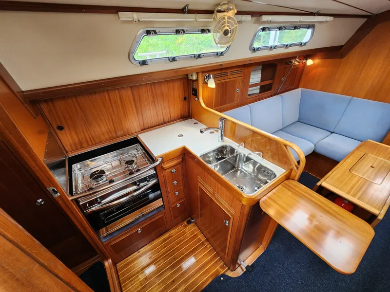 Slide: The Image of Interior of 2016 Hallberg-Rassy 342 yacht with kitchen and seating area. - 35