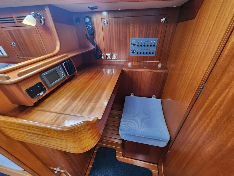 Slide: The Image of 2016 Hallberg-Rassy 342 yacht interior with navigation station and control panel. - 37