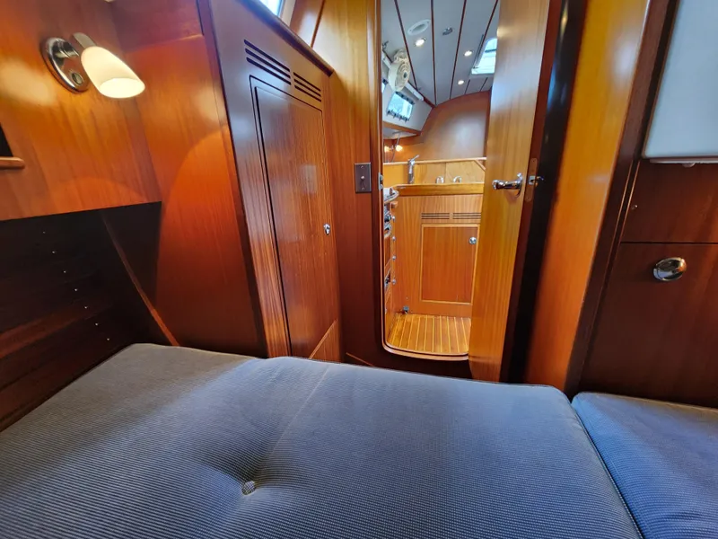 Slide: The Image of Interior of 2016 Hallberg-Rassy 342 yacht, featuring cozy wooden cabin and comfortable seating. - 40