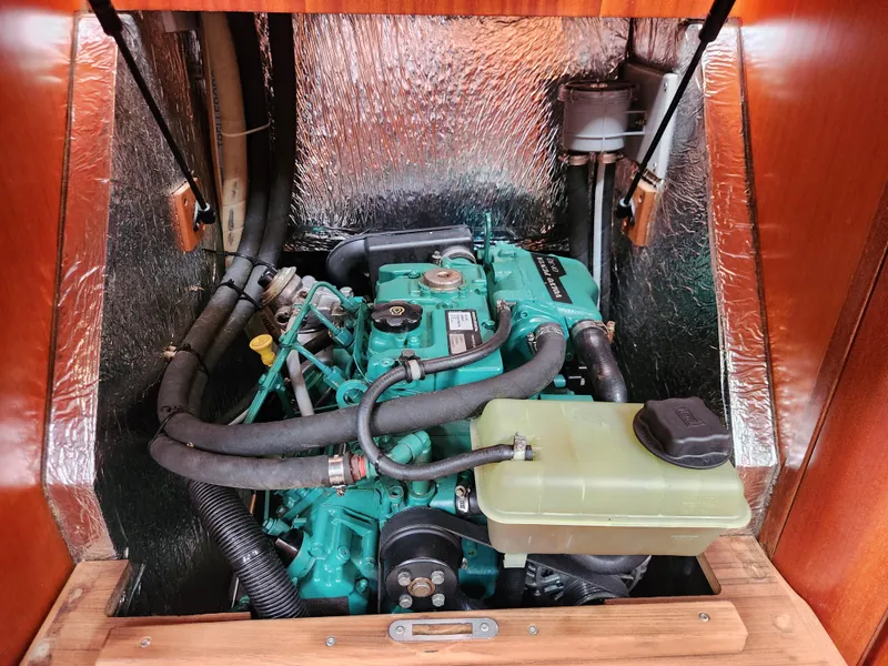 Slide: The Image of Engine compartment of a 2016 Hallberg-Rassy 342 sailboat, featuring a well-maintained marine engine. - 41
