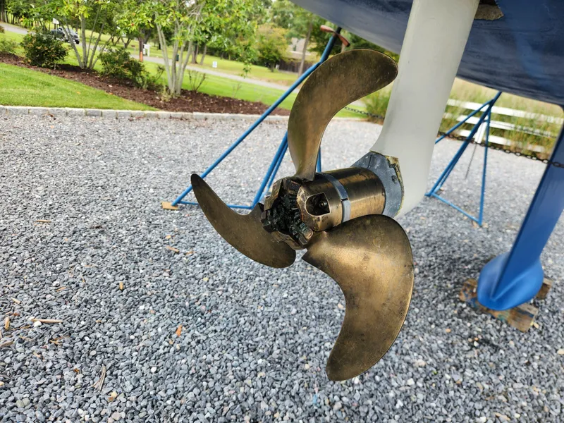 Slide: The Image of Propeller of 2016 Hallberg-Rassy 342 sailboat on gravel, with green foliage background. - 42