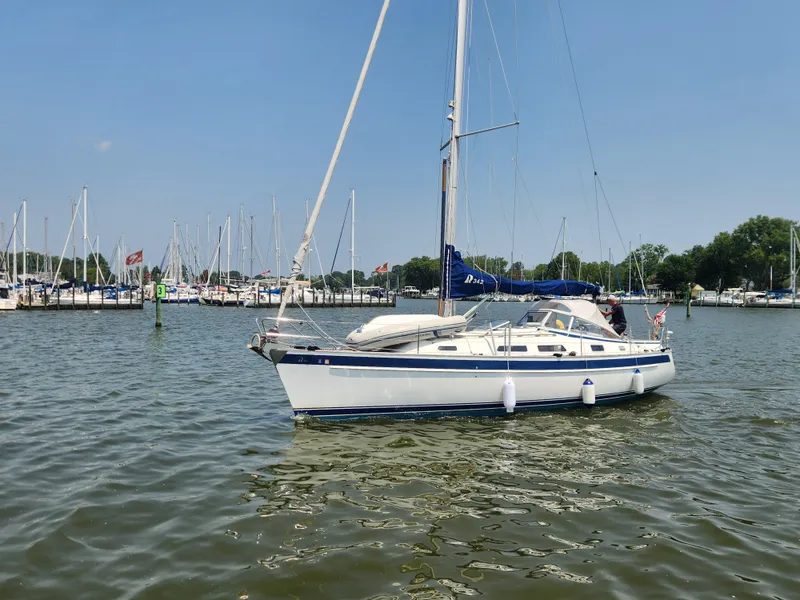 Slide: The Image of 2016 Hallberg-Rassy 342 sailboat docked in a marina under clear blue skies. - 6