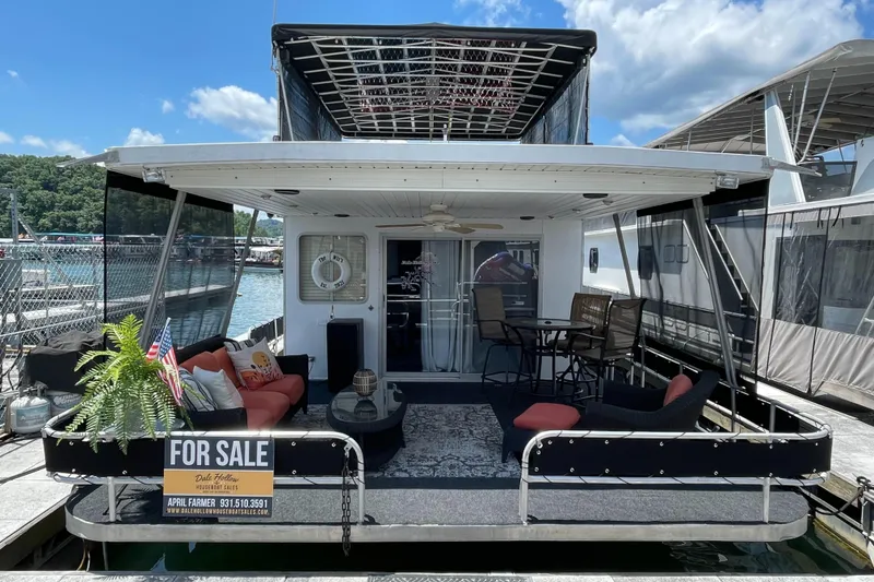 Slide: The Image of 1988 Jamestowner houseboat for sale, docked with outdoor seating and decor. - 1