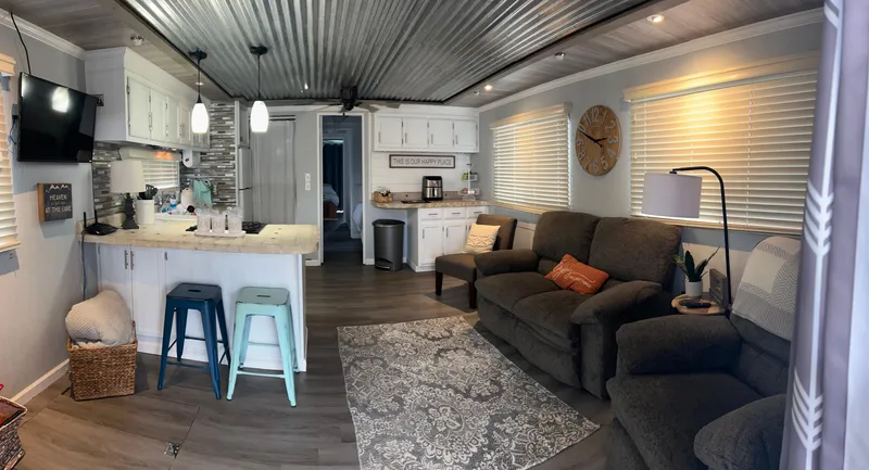 Slide: The Image of Cozy 1988 Jamestowner houseboat interior with modern kitchen, seating area, and stylish decor. - 2