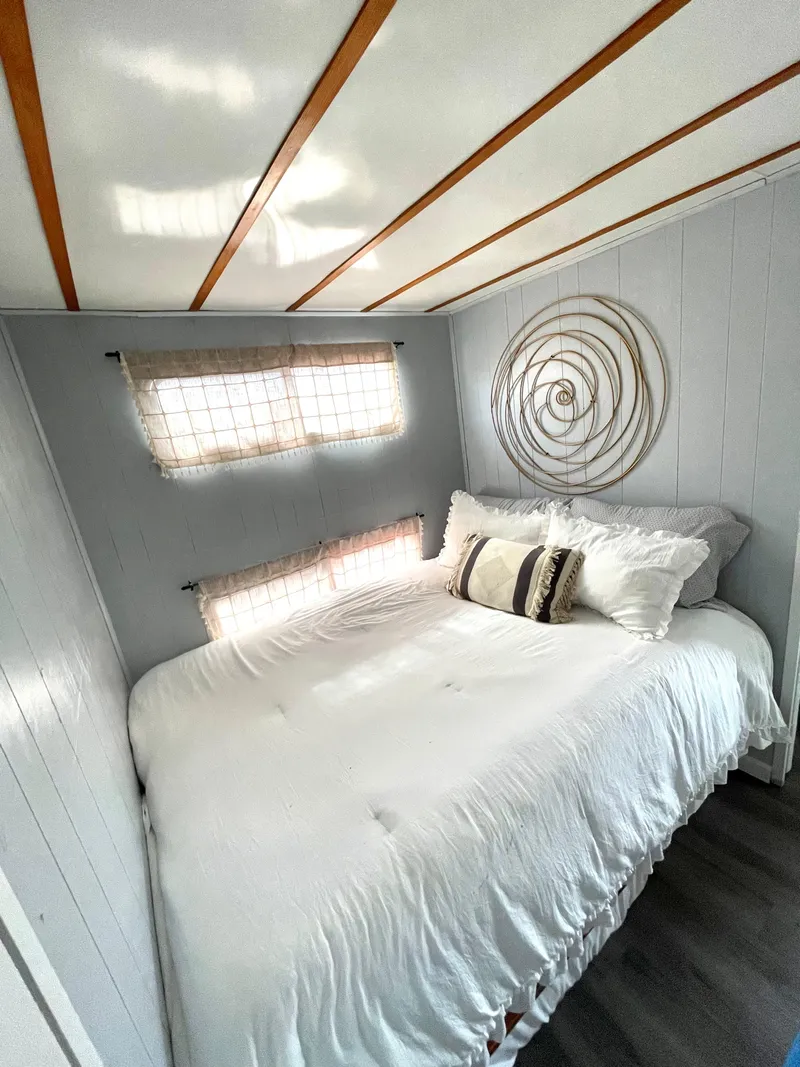 Slide: The Image of Cozy bedroom in 1988 Jamestowner houseboat with modern decor and natural light. - 5
