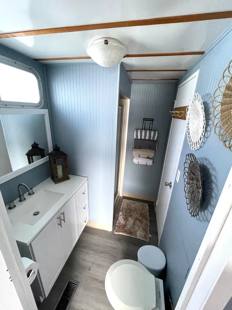 Slide: The Image of 1988 Jamestowner houseboat bathroom with blue walls, modern fixtures, and decorative accents. - 8