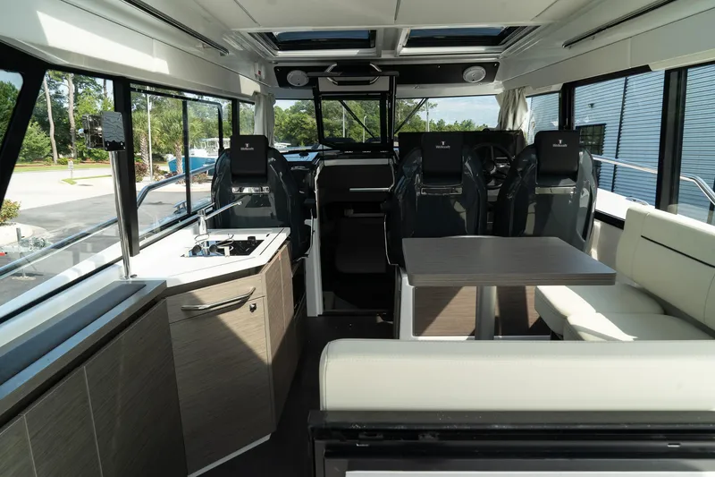 Slide: The Image of Interior of 2025 Wellcraft 355 boat, featuring modern seating and kitchenette. - 14