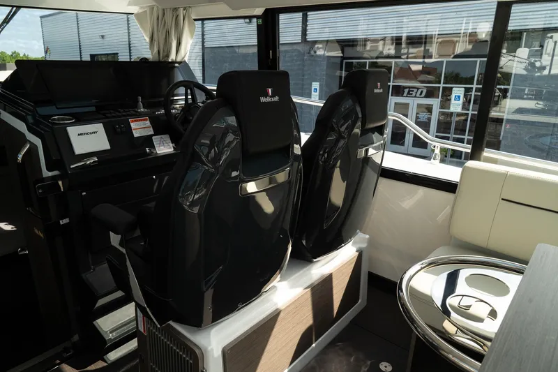 Slide: The Image of Interior of 2025 Wellcraft 355 boat with modern helm and seating. - 16